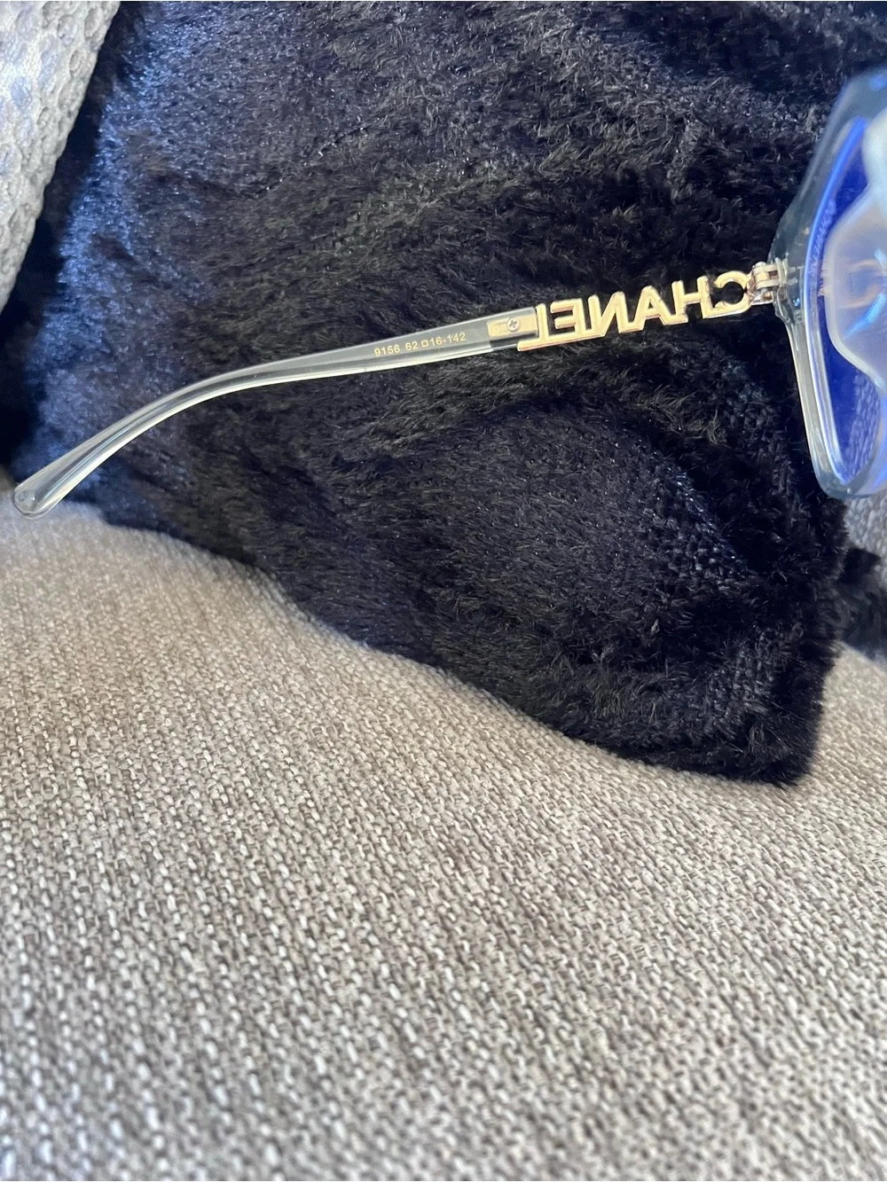 CHANEL Transparent Light Blue Frame Glasses with Gold Logos